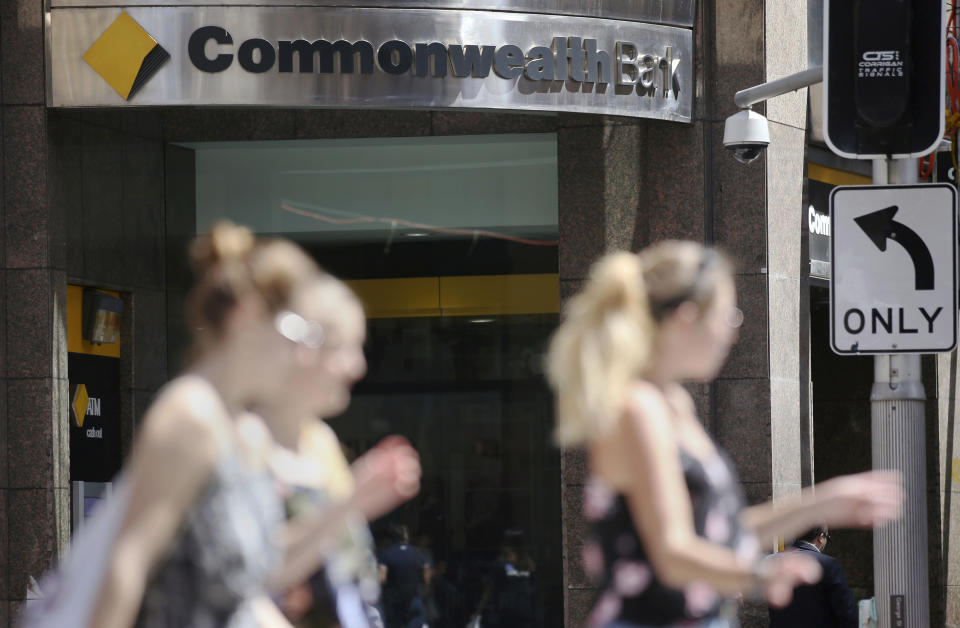 The Commonwealth Bank branding is displayed at its branch in Sydney, Wednesday, Feb. 6, 2019. The Commonwealth Bank of Australia recorded a drop in statutory net profit in its latest half-year to 4.6 billion Australian dollars ($3.3 billion) as the nation's biggest lender was hit by costs for misconduct as well as lower profit margins and a downturn in the housing market. (AP Photo/Rick Rycroft)