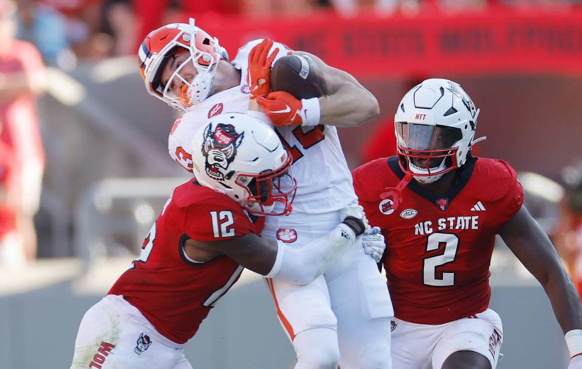 Clemson wide receiver Brannon Spector (13) makes the reception as N.C. State defensive back Devan Boykin (12) hits him during the first half of N.C. State’s game against Clemson at Carter-Finley Stadium in Raleigh, N.C., Saturday, Oct. 28, 2023. Ethan Hyman/ehyman@newsobserver.com