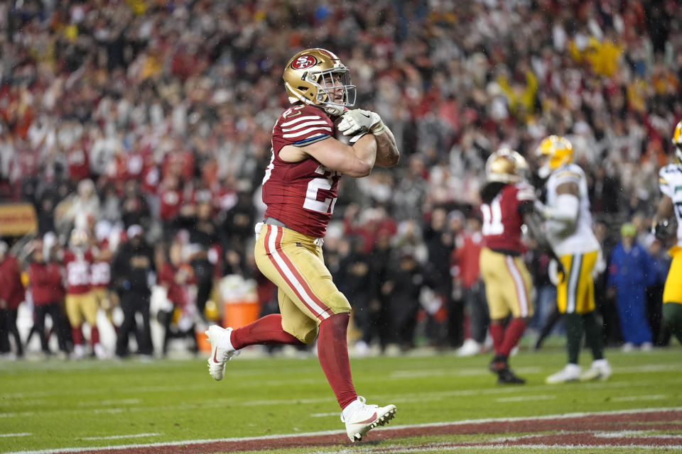 San Francisco 49ers running back Christian McCaffrey (23) scores a rushing touchdown during the second half of an NFL football NFC divisional playoff game against the Green Bay Packers Saturday, Jan. 20, 2024, in Santa Clara, Calif. (AP Photo/Ashley Landis)