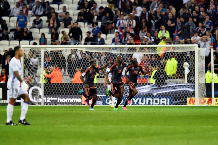 Lorient's Cameroonian forward Benjamin Moukandjo (R) celebrates with teammates after scoring a goal against Lyon on April 8, 2017, at the Parc Olympique Lyonnais