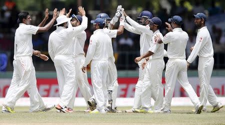 India's Ravichandran Ashwin celebrates with his teammates after taking the catch to dismiss Sri Lanka's Lahiru Thirimanne (not pictured) during the final day of their third and final test cricket match in Colombo, September 1, 2015. REUTERS/Dinuka Liyanawatte