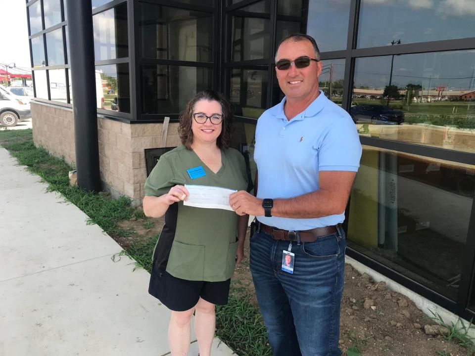 John Lambert, Regional Manager of Atomic Credit Union, presents a donation check to Shelli Speakman, Executive Director and Licensed Wildlife Rehabilitator of Mutt Farm Wildlife Rehabilitation, at the new Atomic Credit Union Branch located at 130 Crites Rd in Circleville, Ohio. This branch will be opening September 22, 2023.