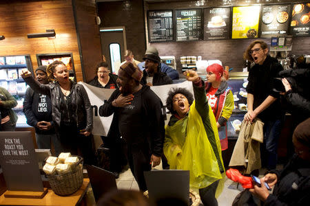 Protestors demonstrate inside a Center City Starbucks, where two black men were arrested, in Philadelphia, Pennsylvania, U.S., April 16, 2018. REUTERS/Mark Makela