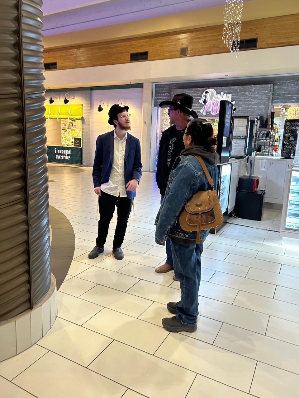 Moshe Faygen, part of the Roving Rabbis, explains the ceremony to some local onlookers who enjoyed the festive music.