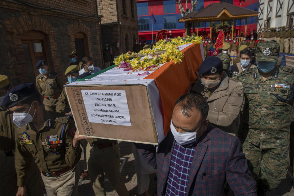 Indian police officers carry the coffin of their colleague Rameez Ahmad during a wreath laying ceremony in Srinagar, Indian controlled Kashmir, Thursday, April 1, 2021. Gunmen in disputed Kashmir on Thursday killed a policeman as they tried to storm the residence of a politician of India's ruling party, police said. (AP Photo/ Dar Yasin)