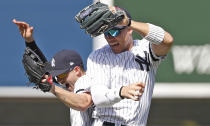 CORRECTS TAYLOR TO LEFT - New York Yankees second baseman Tyler Wade, left, celebrates with right fielder Aaron Judge after the Yankees defeated the Chicago White Sox 4-0 in a baseball game, Saturday, April 13, 2019, in New York. (AP Photo/Kathy Willens)