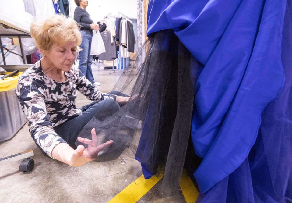 Bonnie Brinkley volunteers her talents to hem a prom dress for a Washington High School student at the Bear Hugs prom pop-up shop. For the past three weeks students from more than 16 school districts in Stark, Summit, Tuscarawas and Carroll counties have visited the shop for a personalized shopping experience.