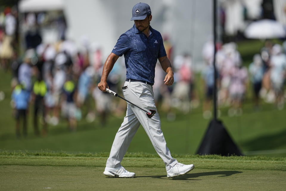 Xander Schauffele lines up a putt on the fifth green during the third round of the Tour Championship golf tournament, Saturday, Aug. 26, 2023, in Atlanta. (AP Photo/Mike Stewart)