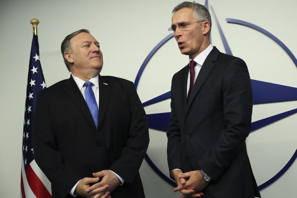 U.S. Secretary of State Mike Pompeo, left, is welcomed by NATO Secretary General Jens Stoltenberg after arriving for a NATO Foreign Ministers meeting at the NATO headquarters in Brussels, Wednesday, Nov. 20, 2019. (AP Photo/Francisco Seco, Pool)