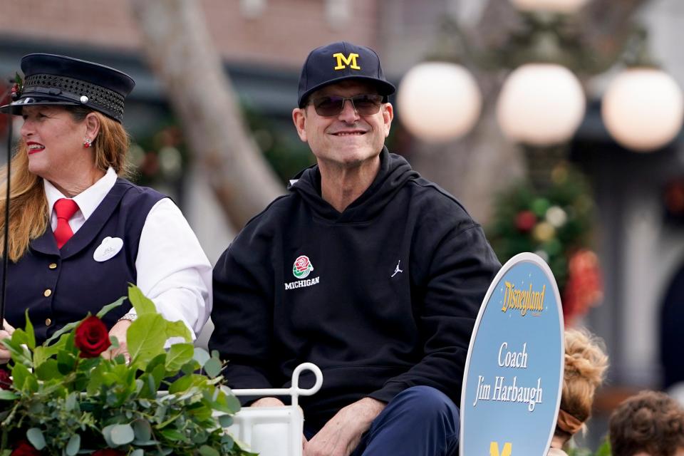 Michigan coach Jim Harbaugh smiles during a welcome event for the team at Disneyland.