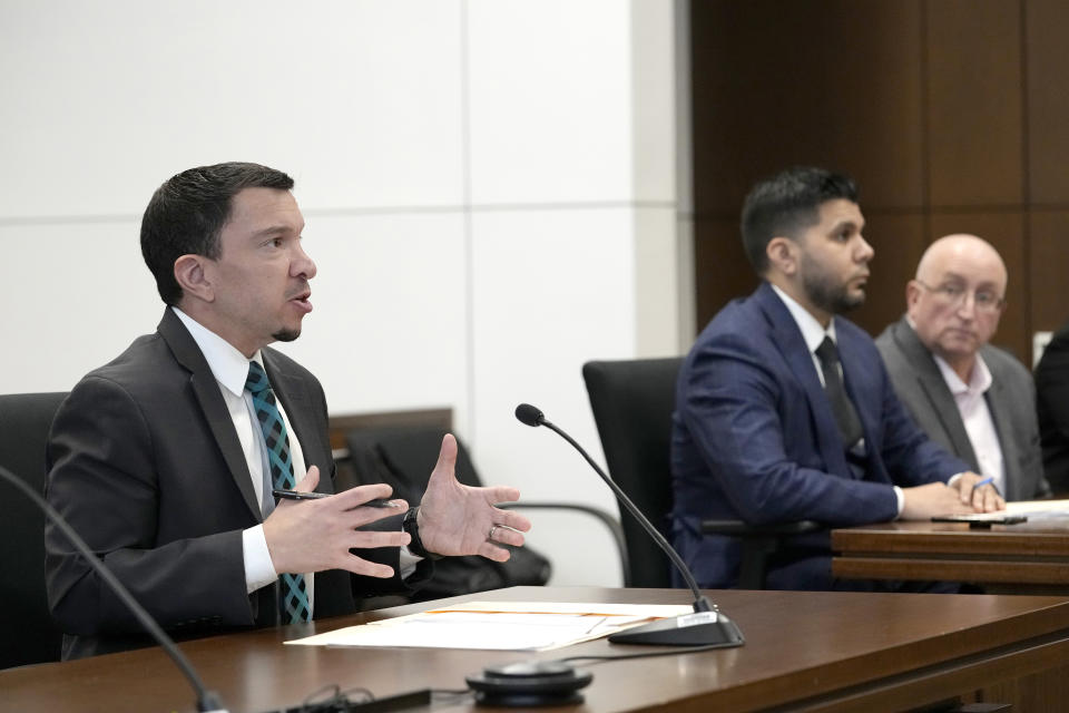 Assistant State's Attorney Jeffrey Facklam, left, address Judge George D. Strickland at the Lake County, Ill., Courthouse Thursday, Jan. 26, 2023, in Waukegan, Ill. Listening to Facklam are Robert E. Crimo Jr., father of Robert Crimo III, right, and his attorney George Gomez. Crimo Jr., faces seven counts of felony reckless conduct for signing the application for his son's firearm owners ID card in December of 2019. (AP Photo/Nam Y. Huh, Pool)