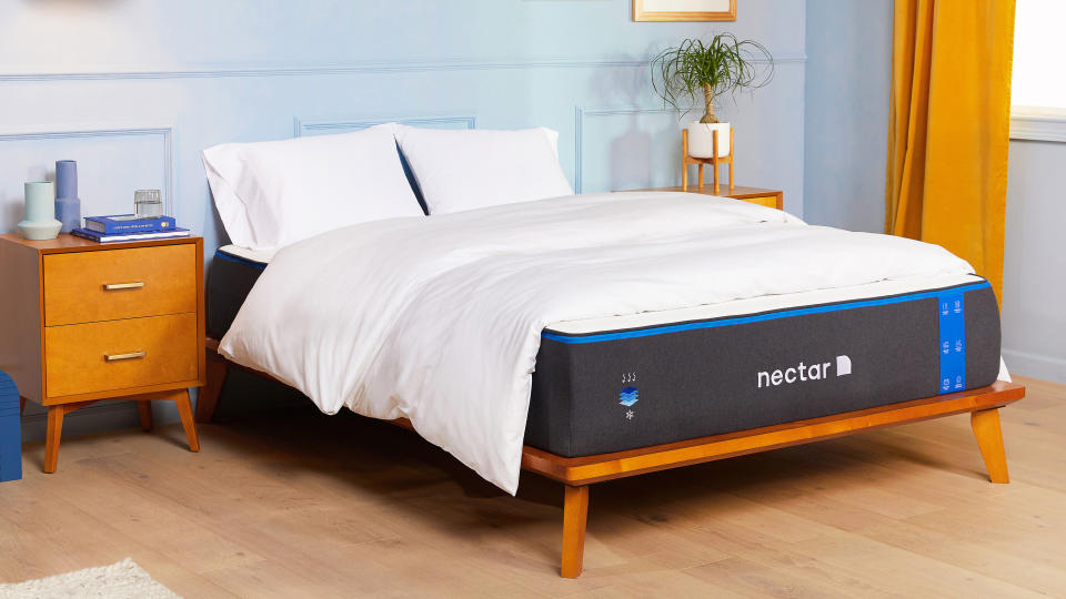 best mattress 2022: the Nectar Memory Foam mattress dressed with a white comforter and placed on a wooden bedframe