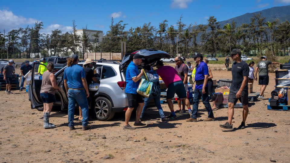 Volunteers unload supplies to be transported to people in need at Kahului Harbor in Maui, Hawaii, on Saturday. - Evelio Contreras/CNN