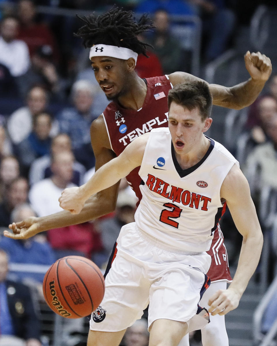 Belmont's Grayson Murphy (2) and Temple's Quinton Rose, left, scramble for the ball during the first half of a First Four game of the NCAA college basketball tournament, Tuesday, March 19, 2019, in Dayton, Ohio. (AP Photo/John Minchillo)