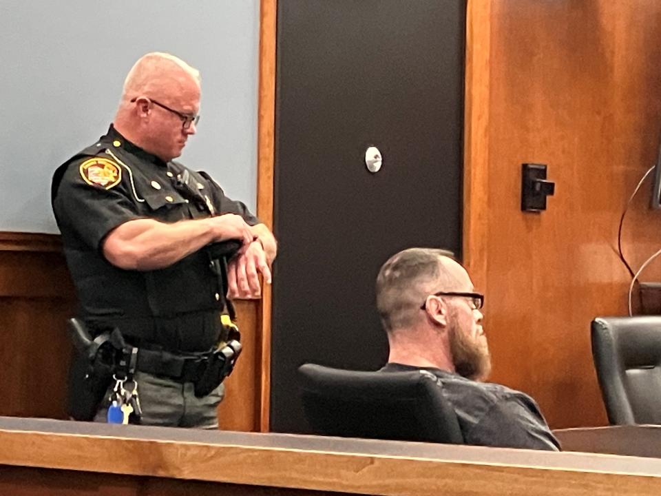 Chad Henthorn, sitting, was found guilty of five of nine counts but was acquitted of attempted murder. Sgt. Keith Krupa is standing next to the defendant.