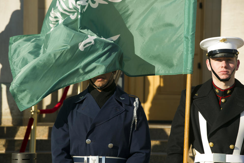 FILE - In this March 22, 2018 file photo, an honor guard member is covered by the flag of Saudi Arabia as Defense Secretary Jim Mattis welcomes Saudi Crown Prince Mohammed bin Salman to the Pentagon, in Washington. Fifteen of the 19 Sept. 11 hijackers were Saudi citizens. Much has been said of the Bush administration’s decision to apportion no blame to the kingdom. The uncomfortable truth that Wahhabism, the ultraconservative Islamic doctrine Saudi's follow, has been linked to extremists at home and overseas has been carefully navigated by Washington and Riyadh. (AP Photo/Cliff Owen, File)