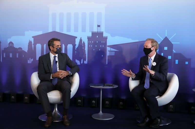 President of Microsoft Brad Smith speaks with Greek Prime Minister Kyriakos Mitsotakis, in Athens