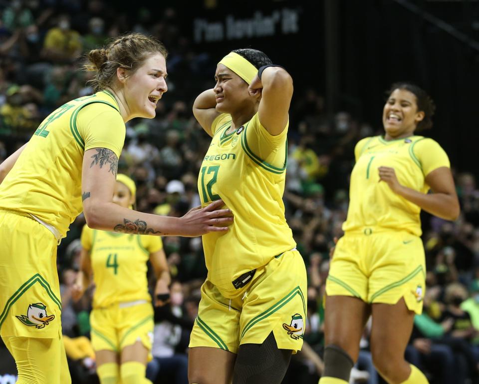 Oregon's Sedona Prince, left, congratulates a flexing Te-Hina Paopao after one of her 3-point shots fall against UConn during the second half Jan. 17, 2022.