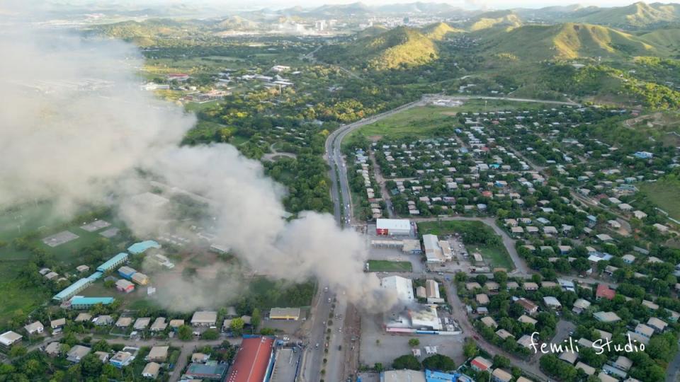 Aerial view shows a burning building amid protests over a pay cut for police that officials blamed on an administrative glitch, in Port Moresby (Femli Studio via REUTERS)