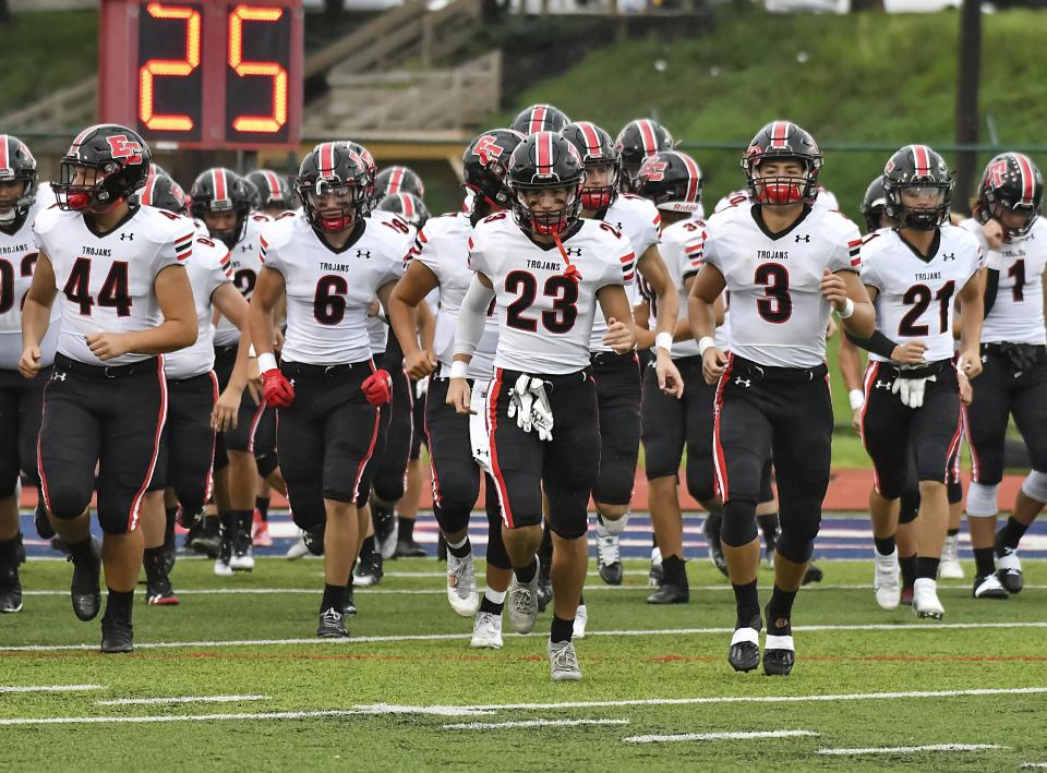 The East Central Trojans run onto the field to play against Moeller at Shea Stadium on Saturday, Sept. 3, 2022.