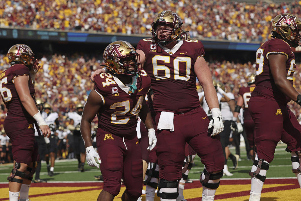 Minnesota running back Mohamed Ibrahim (24) celebrates with offensive lineman John Michael Schmitz (60) after Ibrahim scored a touchdown against Colorado during the first half of an NCAA college football game, Saturday, Sept. 17, 2022, in Minneapolis. (AP Photo/Stacy Bengs)
