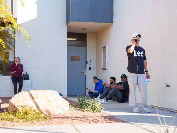 eople wait on the outskirts of the UNLV campus after a shooting on 6 December 2023 in Las Vegas, Nevada (Getty Images)