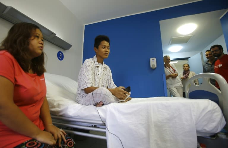 Siblings Sarah (L) and Reynaldo Nilo sit in a hospital room in the Sudanese capital, Khartoum, on July 1, 2015