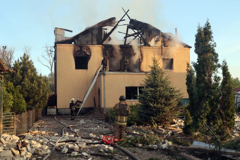 Firefighters extinguish a house after a Russian missile attack on Kharkiv, northeastern Ukraine. -/Ukrinform/dpa