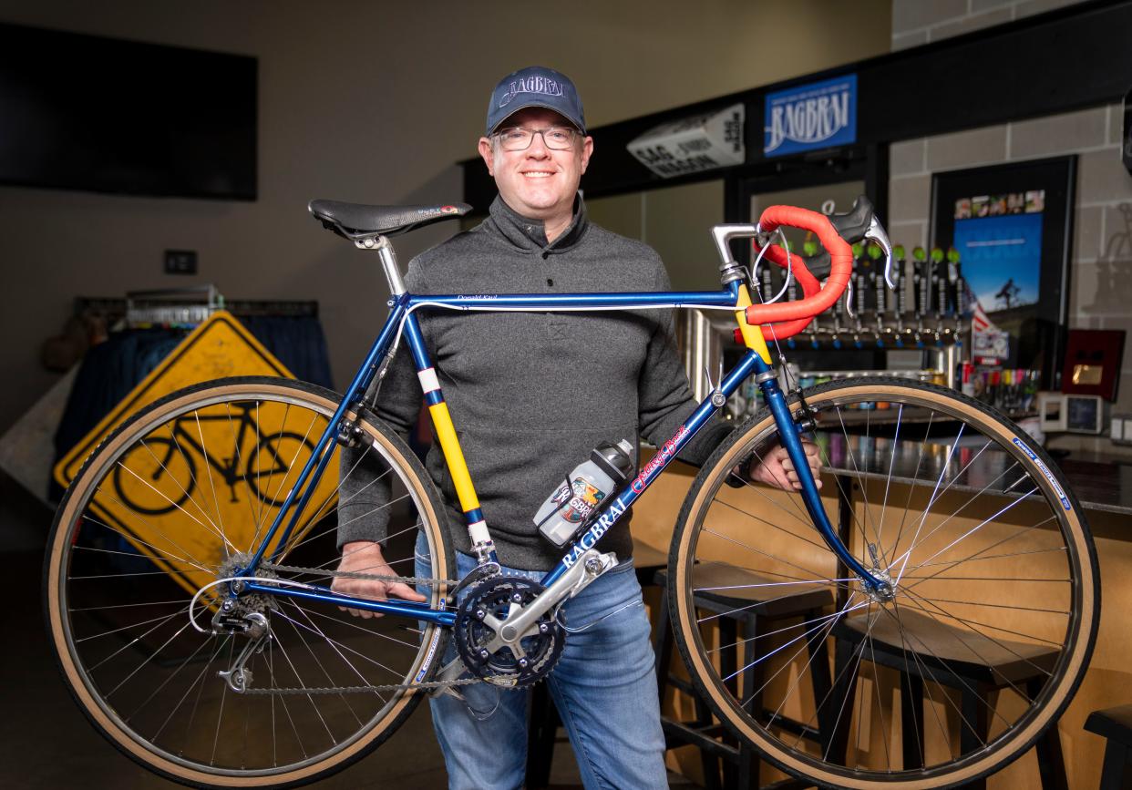 RAGBRAI Ride Director Matt Phippen holds a bike that was built for RAGBRAI co-founder Donald Kaul, at the RAGBRAI office in Des Moines, Tuesday, Jan. 23, 2024.