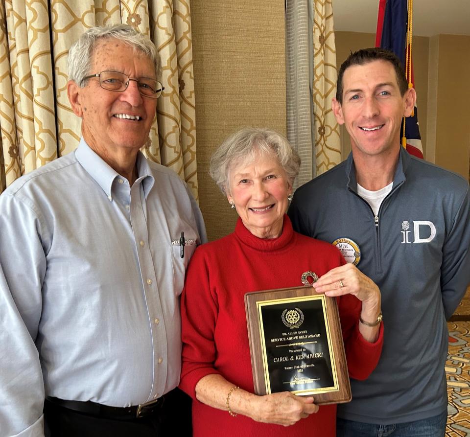 Ken and Carol Apacki are presented the Granville Rotary Service Above Self Award by club president, Steve Hitchcock (right).