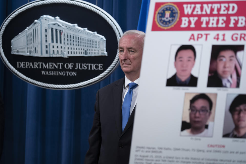 Deputy Attorney General Jeffery Rosen listens, Wednesday, Sept. 16, 2020 at the Justice Department in Washington. The Justice Department has charged five Chinese citizens with hacks targeting more than 100 companies and institutions in the United States and abroad, including social media and video game companies as well as universities and telecommunications providers. Officials announced the prosecution on Wednesday. (Tasos Katopodis/Pool via AP)