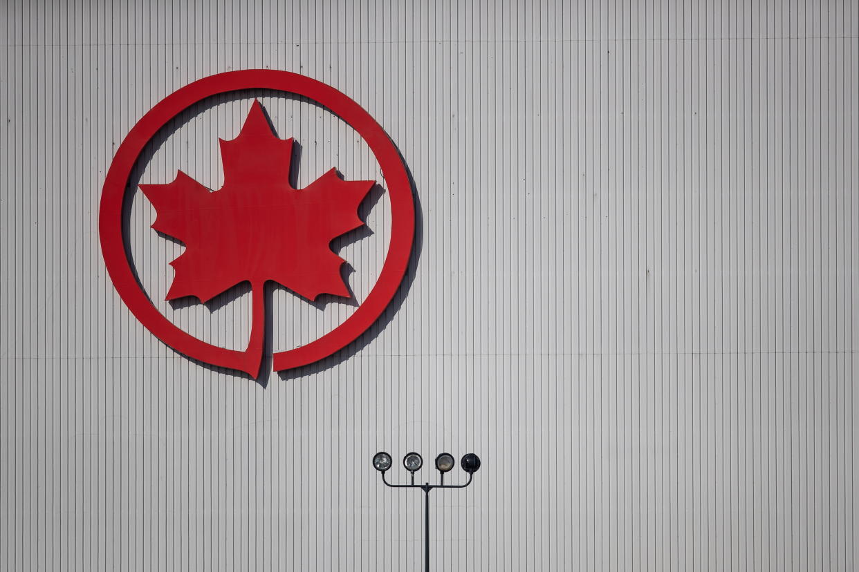 The Air Canada logo is seen on a hangar at Vancouver International Airport, in Richmond, B.C., on Friday, March 20, 2020. Air Canada has signed a deal to buy 30 electric-hybrid aircraft under development by Swedish company Heart Aerospace.THE CANADIAN PRESS/Darryl Dyck