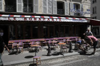 Waiters prepare the terrace of a restaurant in order to respect distancing measures in Paris, Monday, June 1, 2020, as France gradually lifts its Covid-19 lockdown. France is reopening tomorow its restaurants, bars and cafes as the country eases most restrictions amid the coronavirus crisis. (AP Photo/Christophe Ena)