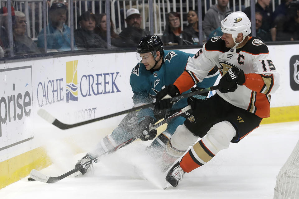 San Jose Sharks' Dylan Gambrell, left, reaches for the puck next to Anaheim Ducks center Ryan Getzlaf (15) during the first period of an NHL hockey game in San Jose, Calif., Monday, Jan. 27, 2020. (AP Photo/Jeff Chiu)