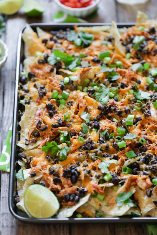 <p>These baked nachos are the perfect meal for a busy evening. Get the recipe <a href="http://livesimply.me/2015/06/25/30-minute-chicken-and-black-bean-nachos/" rel="nofollow noopener" target="_blank" data-ylk="slk:HERE;elm:context_link;itc:0;sec:content-canvas" class="link "><strong>HERE</strong></a>.</p>