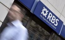 A man walks past a branch of The Royal Bank of Scotland (RBS) in central London in this August 27, 2014 file photo. REUTERS/Toby Melville/Files