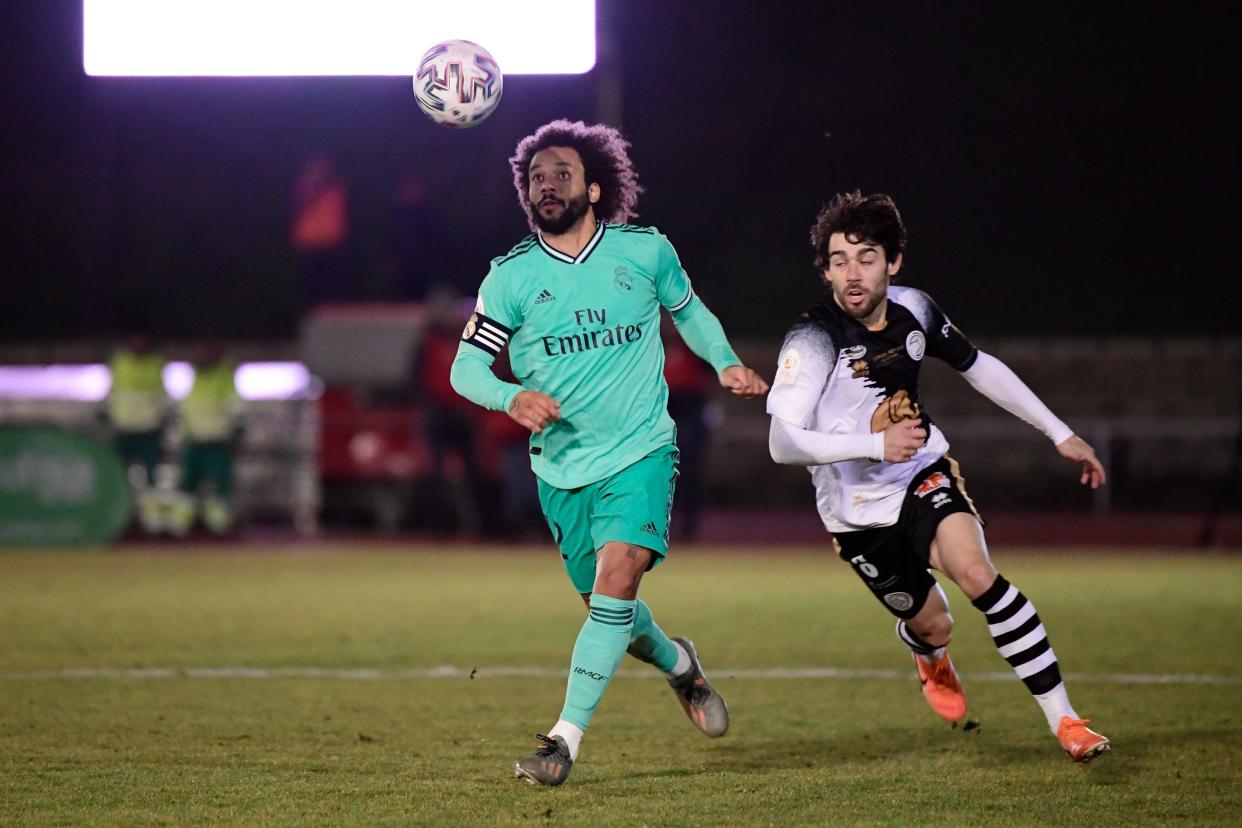 Real Madrid's Brazilian defender Marcelo (L) vies with Unionistas' Spanish defender Ayoze Placeres during the Copa del Rey (King's Cup) football match between Unionistas de Salamanca CF and Real Madrid CF at Las Pistas del Helmantico stadium in Salamanca, on January 22, 2020. (Photo by JAVIER SORIANO / AFP) (Photo by JAVIER SORIANO/AFP via Getty Images)