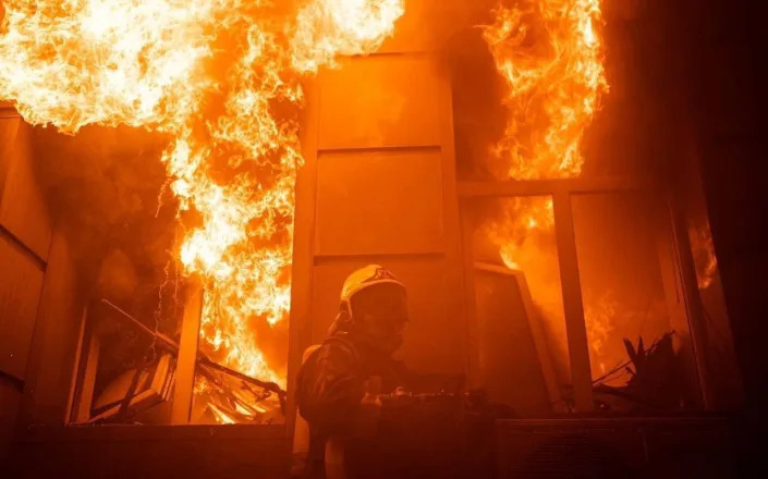 Firefighters extinguish fire at damaged house after attacks in Odesa