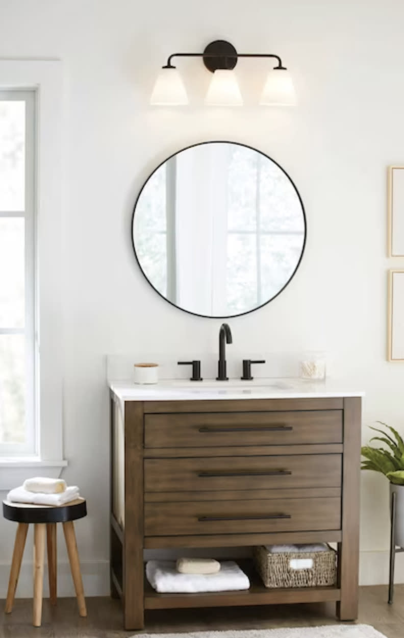 mirror hung above sink in decorated bathroom