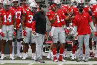 Ohio State head coach Ryan Day, left, talk with quarterback Justin Fields during the second half of their NCAA college football game against Nebraska Saturday, Oct. 24, 2020, in Columbus, Ohio. Ohio State defeated Nebraska 52-17. (AP Photo/Jay LaPrete)