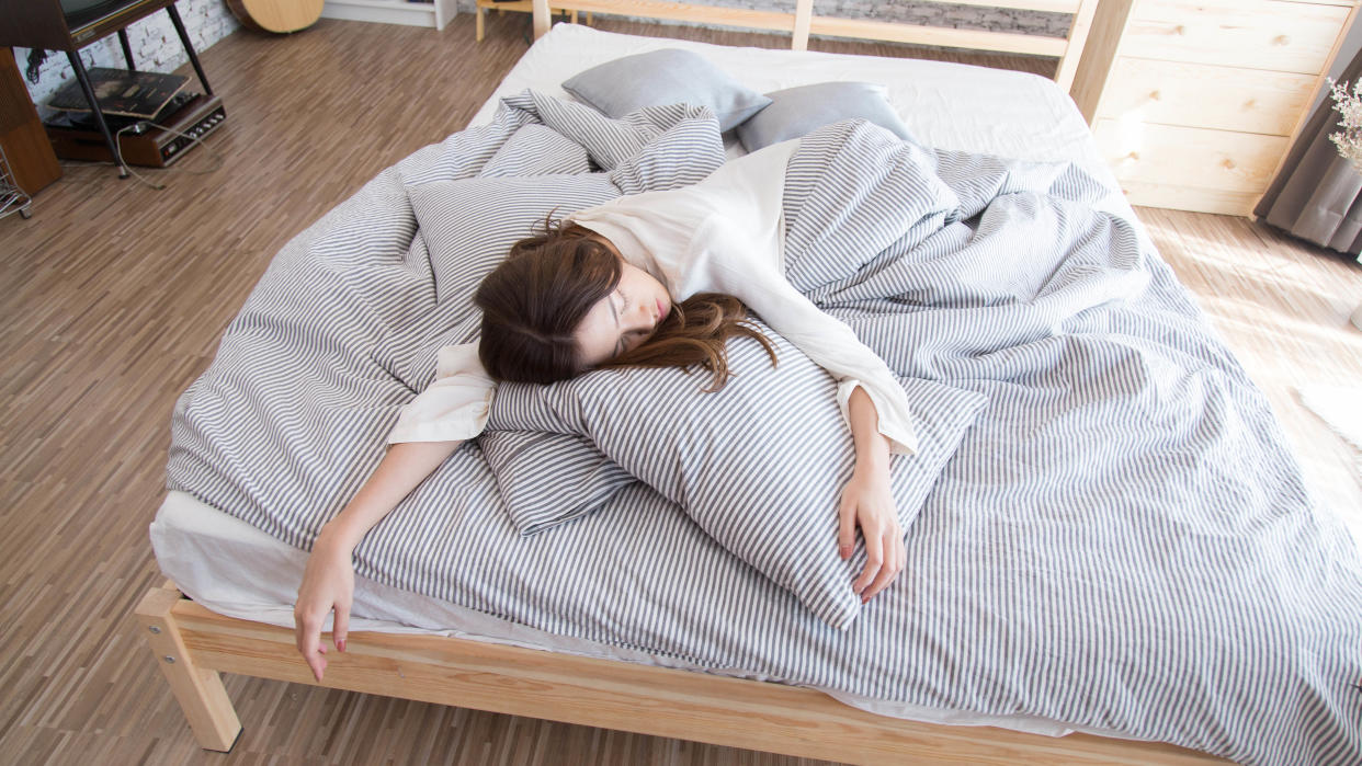  Woman sleeping at the end of bed. 