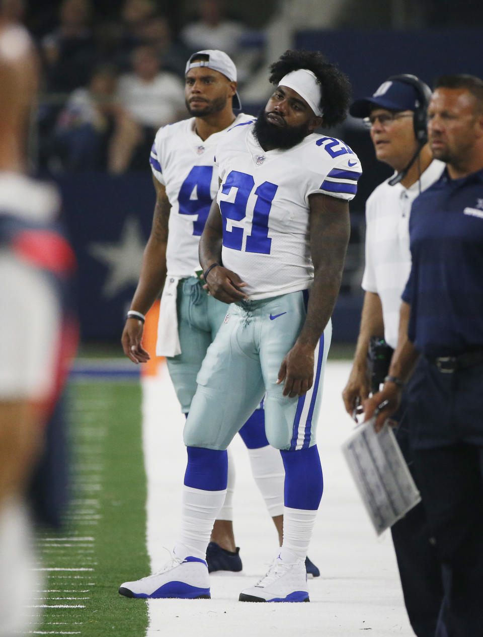 Dallas Cowboys running back Ezekiel Elliott (21) and quarterback Dak Prescott (4) stand on the sideline during the second half of a preseason NFL football game against the Cincinnati Bengals in Arlington, Texas, Saturday, Aug. 18, 2018. (AP Photo/Ron Jenkins)