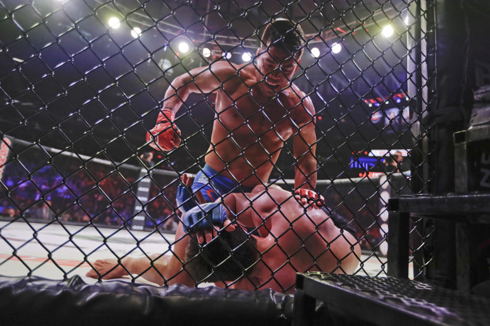 Brazil's Lyoto Machida, above, punches Chael Sonnen during the second round of a light heavyweight mixed martial arts bout at Bellator 222 early Saturday, June 15, 2019, in New York. Machida stopped Sonnen in the second round. (AP Photo/Frank Franklin II)