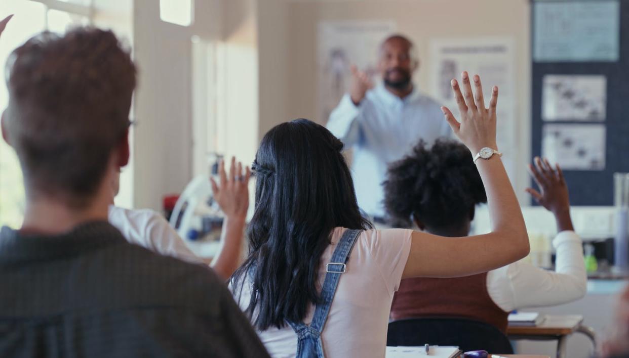 Bans on critical race theory target teachers and curriculums. <a href="https://www.gettyimages.com/detail/photo/rearview-shot-of-students-raising-their-hands-royalty-free-image/1324921654?phrase=teacher%20high%20school&adppopup=true" rel="nofollow noopener" target="_blank" data-ylk="slk:Kobus Louw via Getty Images;elm:context_link;itc:0;sec:content-canvas" class="link ">Kobus Louw via Getty Images</a>