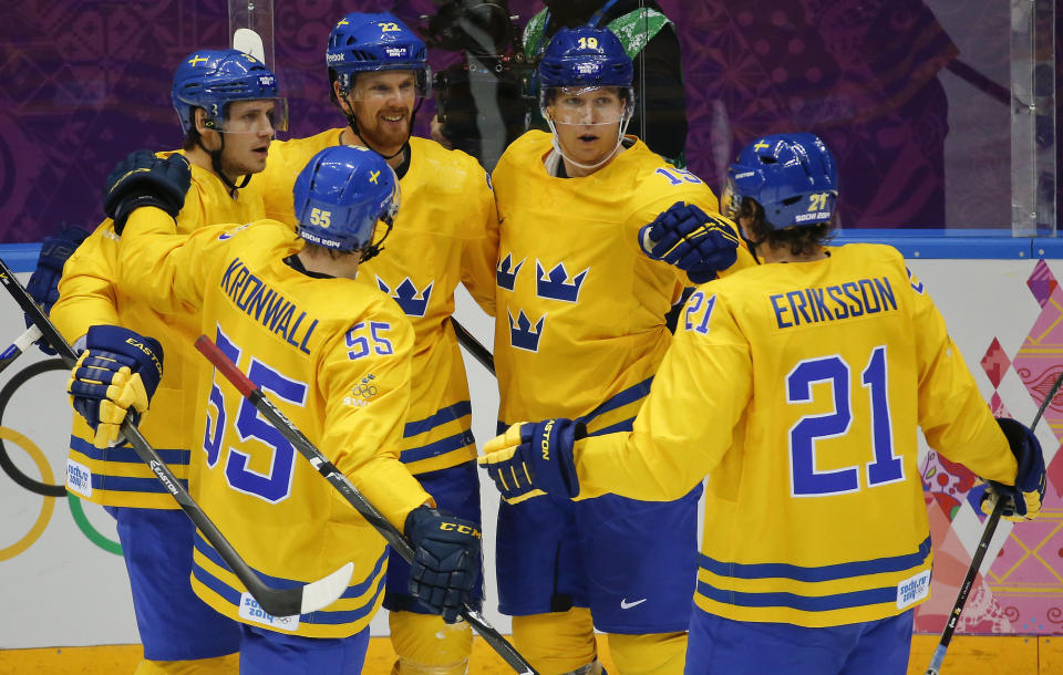 Team Sweden celebrates a third period goal against Slovenia during a men's quarterfinal ice hockey game at the 2014 Winter Olympics, Wednesday, Feb. 19, 2014, in Sochi, Russia. (AP Photo/Mark Humphrey)