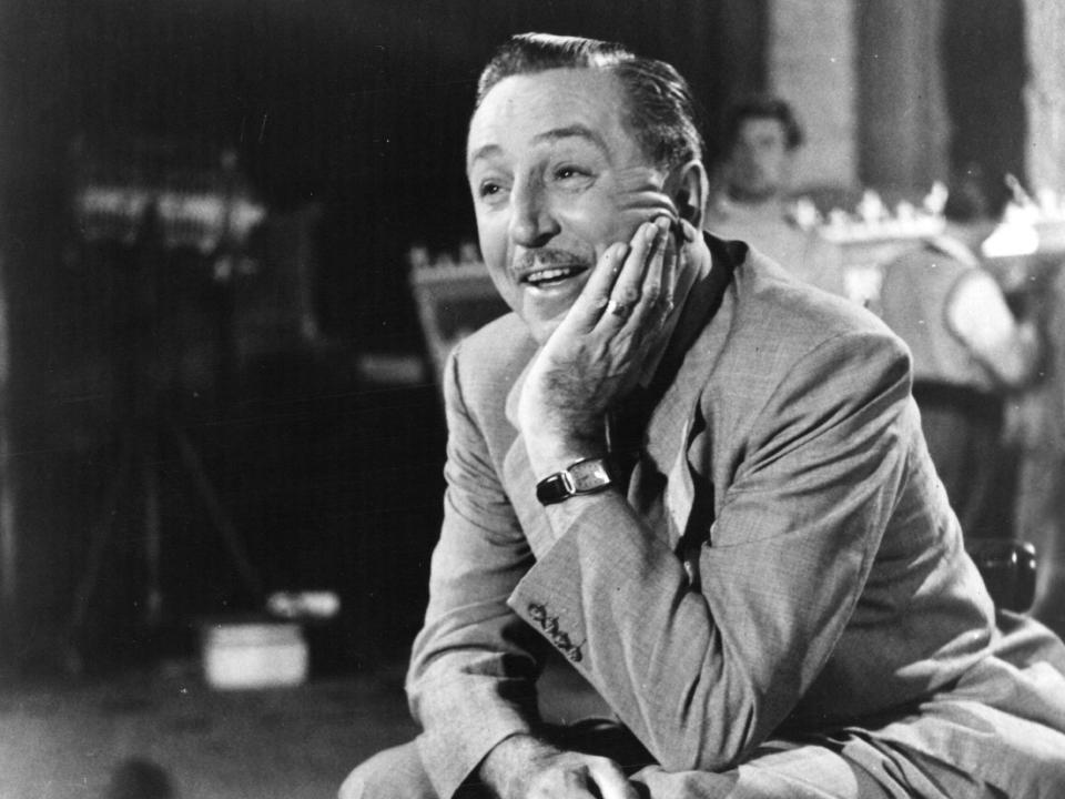 a black and white photo of Walt Disney