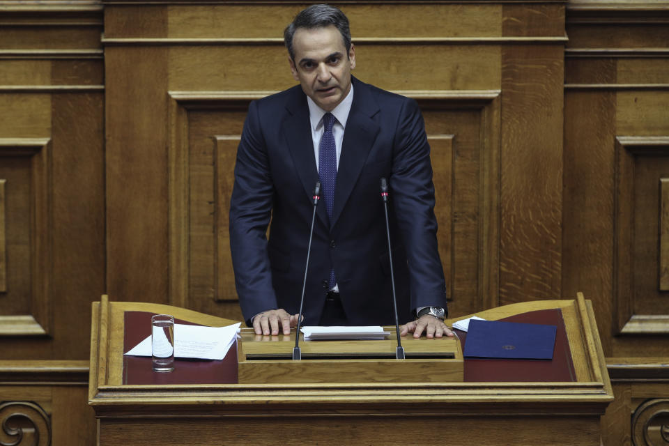 Greece's Prime Minister Kyriakos Mitsotakis addresses lawmakers during a parliamentary session to present his government's policies in Athens, Saturday, July 20, 2019. (AP Photo/Petros Giannakouris)