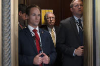 Senate Minority Leader Mitch McConnell of Ky., center, takes an elevator, Tuesday, May 18, 2021, after a meeting with Senate Republicans on Capitol Hill in Washington. (AP Photo/Jacquelyn Martin)