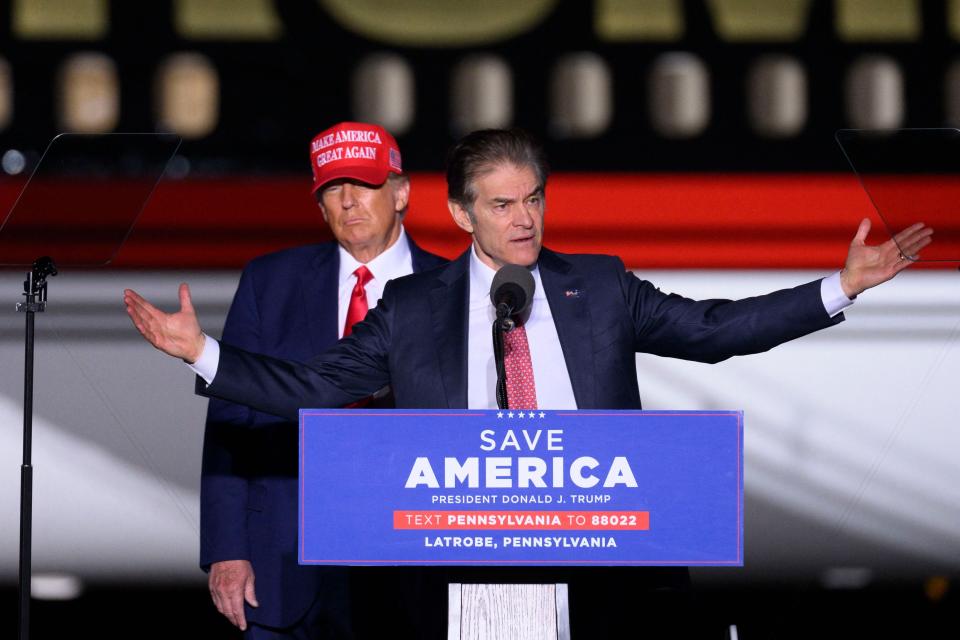 Former President Donald Trump looks on as Republican Senatorial candidate Mehmet Oz at Arnold Palmer Regional Airport in Latrobe, Pennsylvania, on November 5, 2022.  (Angela Weiss / AFP via Getty Images)