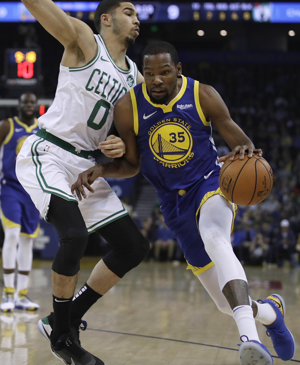 Golden State Warriors' Kevin Durant, right, drives the ball against Boston Celtics' Jayson Tatum during the first half of an NBA basketball game Tuesday, March 5, 2019, in Oakland, Calif. (AP Photo/Ben Margot)